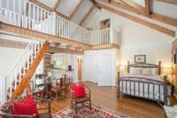 Bedroom 3, complete with it's own covered porch, kitchen, fireplace, loft area, full bath, and private staircase. Would make a great MIL suite.