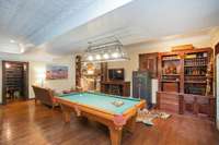 Billiard room on the basement level, with a view of the wine cellar