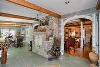 SIde Door Entrance - Dining area and a view of the indoor wood burning grill - Sunroom to the right