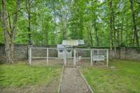 Chicken coop, notice the incredible stone wall behind, that surrounds the main property