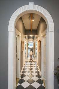 Hallway leading into his/hers bathrooms and walk-in closets on each side