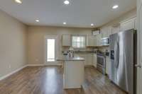 Your kitchen has plenty of cabinets with stainless appliances and storage under the island too.  Cabinets are a pretty neutral beige color that will go with any color you choose.