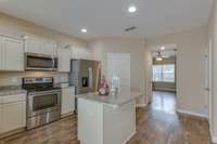 Another view of your pretty kitchen. The flooring is such a wonderful match to the colors in the cabinets and granite counter tops.