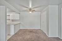 Here is the dining area that opens directly to the bright white kitchen.