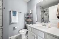 Bathroom within the front bedroom, tile flooring.