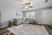 Alternate view including the foyer and front window to your covered porch.  Blinds included and ceiling fan.