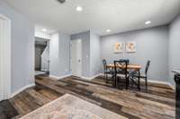 Alternate view including the half bath and walkway to living area with a coat closet.