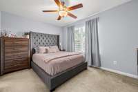 Front bedroom with ceiling fan, walk in closet, ensuite bath with a tile shower and tile floors.