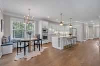 The breakfast nook creates a comfortable spot for casual meals or morning coffee. A custom banquette with storage was thoughtfully added. This space is perfectly sized for intimate gatherings or your favorite card game.