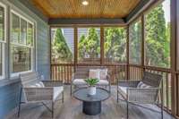 Wind down on the screened-in porch, connected directly from the kitchen and living room and providing plenty of space for lounging and dining.