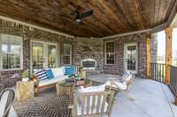 Large covered back porch with entrances to Gathering room and Family room.