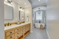 Double vanities with separate soaking tub and large shower.