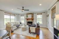 Family room open to kitchen with fireplace and access to back porch.