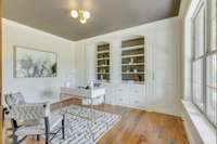 Home office with beautiful built-ins and secret storage panel.