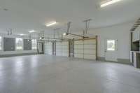 Perfect oversized 3 car garage with Guardian Garage Floor and work areas.