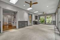 Sunroom with openings to the Family Room, Primary Bathroom, and to the Outdoors.