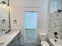 Jack and Jill bath between bedrooms 3 & 4 has double vanities and a tub/shower combo.