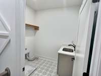 Good sized laundry room with sink.