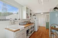 Clean up is extra easy in the laundry room with an additional sink set into another butcher block topped counter space.