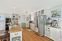 Welcome to the functional and beautiful kitchen.With stainless appliances, real hardwood floors, white cabinetry topped with butcher block counters, you'll love spending time here.