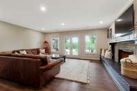 Cozy and Comfortable  basement Den opens to  spacious covered patio. Note the fireplace and long hearth.