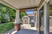 Covered Back Porch with Rolling Privacy Screens on each side.