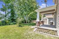 Level Backyard.  Garden on the side of the Covered Porch.