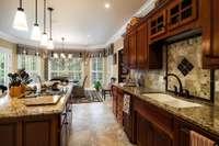 Tall ceilings, custom cherry cabinets, crown molding, tile backsplash, and granite countertops make this kitchen beautiful AND functional!