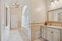 The Primary Bath Suite is truly like a Luxury Spa! It has a beautiful 16" square tile floor. The separate granite vanities are surrounded with half-wall tile adorned by a diamond style boarder with a bullnose accent.