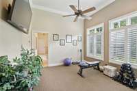 Located across the hall from the Primary Bedroom is this bright room which the Owners use as a home workout area.