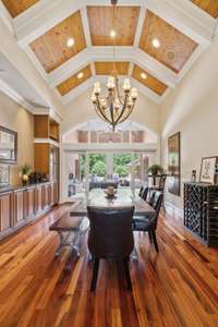 This Dining Room has Galatial Beauty with its Coffered, Bead-Board Barrell Ceiling. The huge windows in the back look out onto the Star Gazing Terrace surrounded by trees and nature.