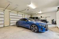 The 4-Car Garage is completely Heated and Cooled. It has room for all your cars plus Supply and Storage Cabinets.