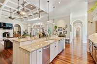 From the Kitchen, it's easy to access two of the bedrooms located down this Arched-Entry Hallway.