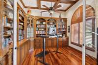 This office Haven offers a beautiful space with plenty of bookcases, cabinets, and shelves for your work needs and collectibles. The Plantation Shutters allow plenty of light and a great view.