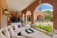 This Picturesque Covered Porch is lit with Carriage House Style Lanterns which give it a soft and elegant glow.