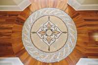 Once you pass through the Foyer, Step onto the Spectacular Hand-Tiled Mosaic Medallion Custom Designed into the Tigerwood floor.