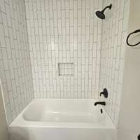 New tub, tile and fixtures.