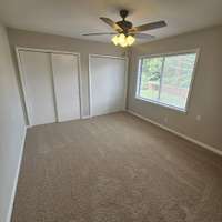 Main bedroom with double closets. new ceiling fan carpet, freshly painted.