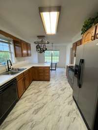 eat in kitchen with new LVP floors and tons of natural light