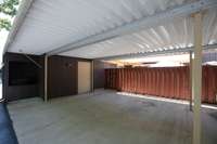 Extra large 2 car carport with walk-in storage