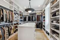 Owners suite closet complete with shelves and an island dresser.