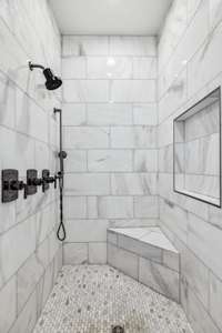 Walk in shower with beautiful tile selection.