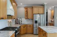 Kitchen with new hard surface countertops and new gas stove. The solid surface is leathered dolomite.