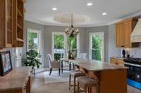 Kitchen with patio door to the deck, waterfall, koi pond and lush landscaping.