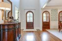 The triple arched doors lead to the front porch. Gorgeous architectural design can be found throughout the home.