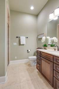 The main level guest suite has a pretty bath with tiled shower.  A separate powder room is also available for visitors.