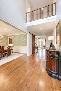 On the right of the entry is a sun soaked study/sitting room. To the left is the beautiful formal dining room with doors that open to the front porch.