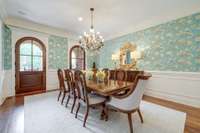 Enjoy hosting in this formal dining room with elegant wainscoting and crown molding trim details.