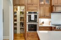 There is ample rich cabinetry and a hidden walk-in pantry for incredible storage.