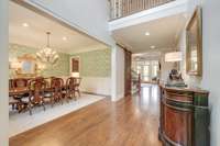 Greet guests into your two story foyer with true sand and finish hardwood floors that can be found throughout the main level.